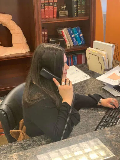 woman on the phone in a personal injury attorney's office