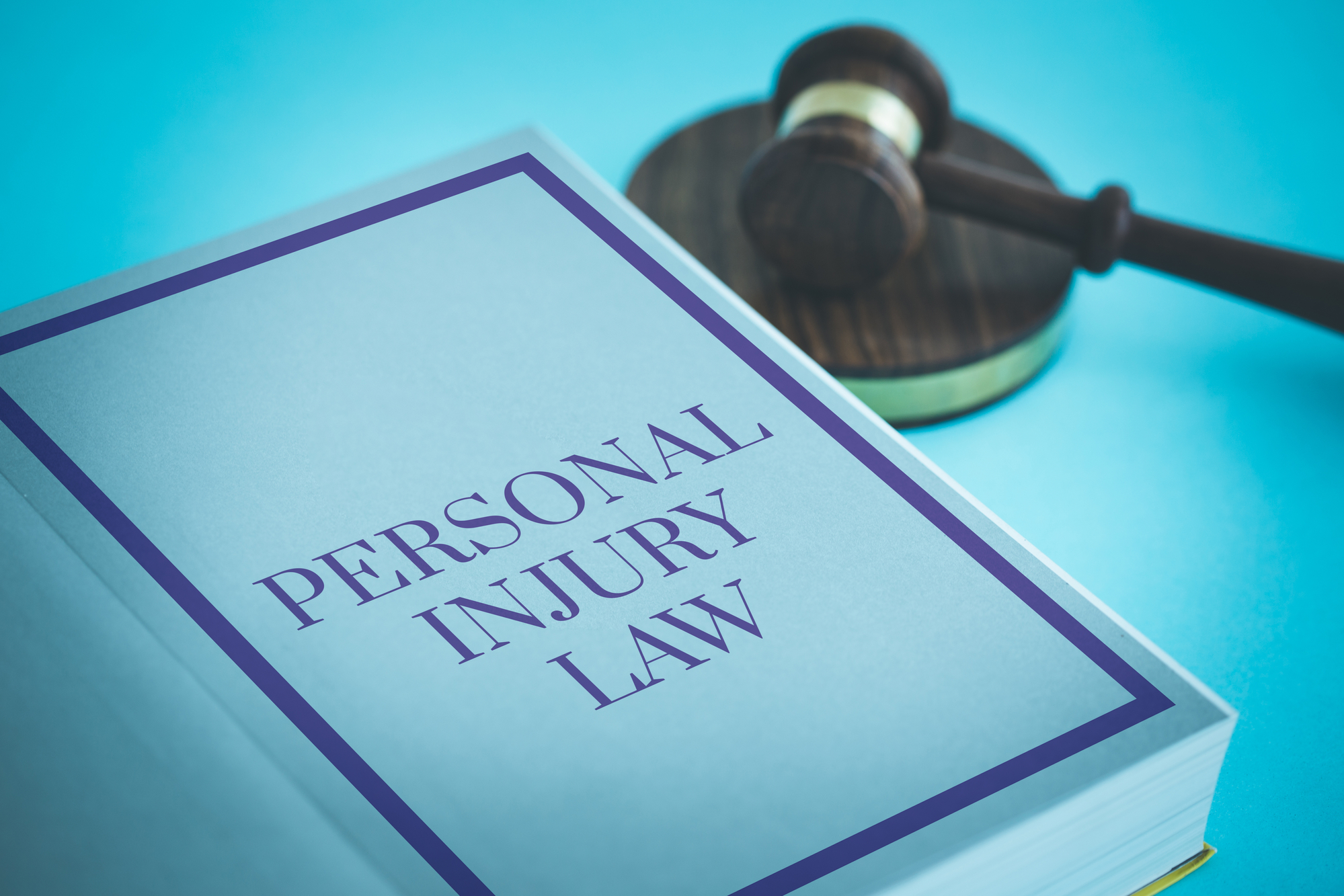 Personal injury book and gavel on the desk at a Riverton UT Law Firm